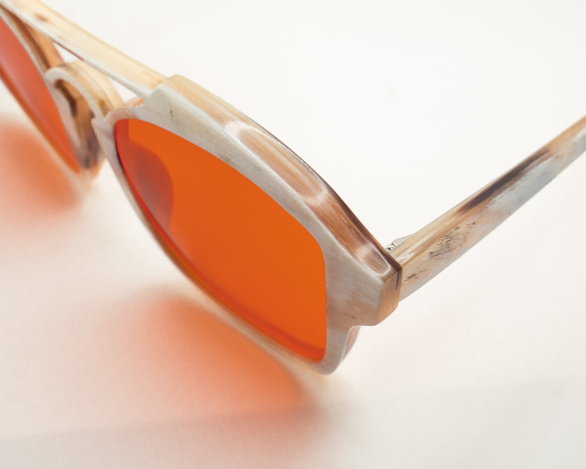 Night blue light blocking glasses with buffalo horn frames, worn on a model