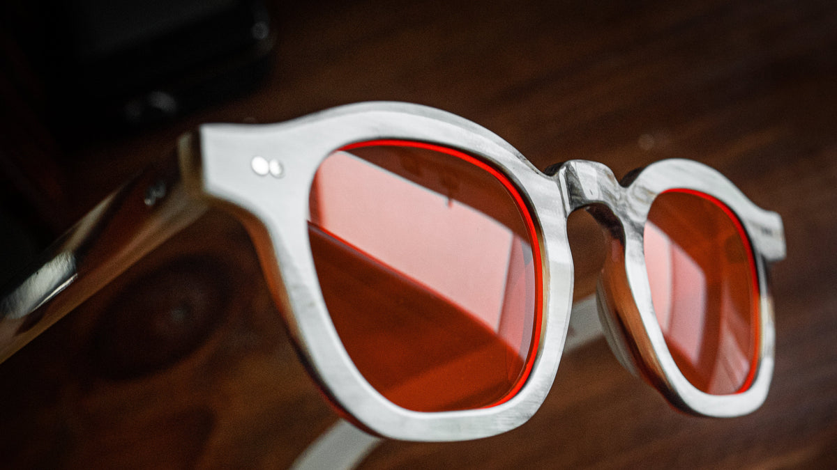 Night blue light blocking glasses with buffalo horn frames, worn on a model