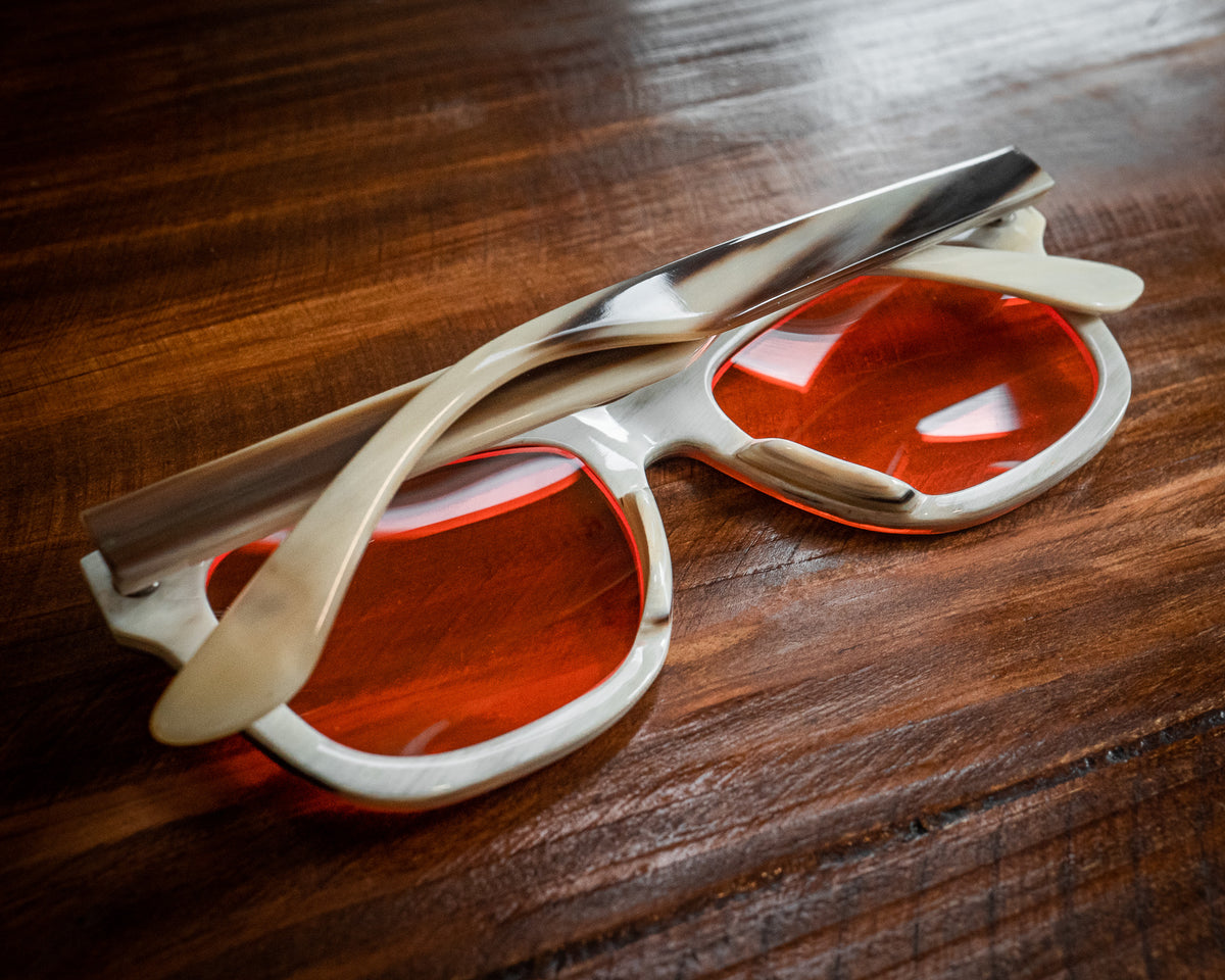 Night blue light blocking glasses with buffalo horn frames, worn on a model