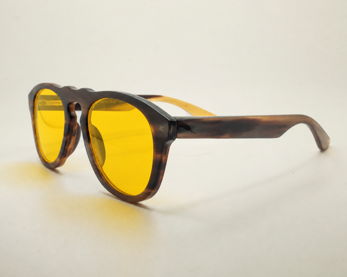 Day blue light blocking glasses with buffalo horn frames, worn on a model